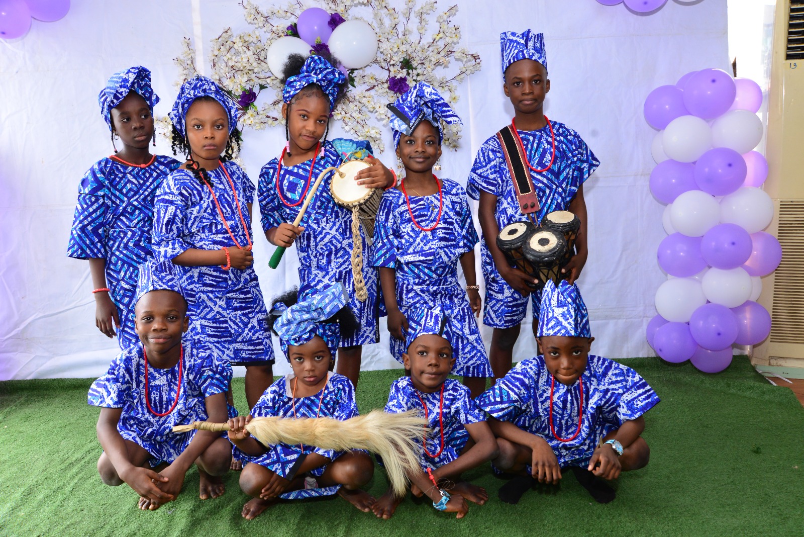 Pupils in traditional attire with talking drums